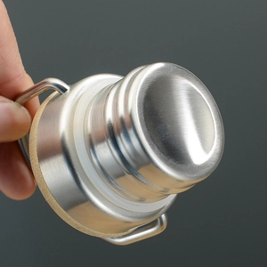 Detail shot of stainless steel bamboo lid with a silicone ring and metal carrying handle