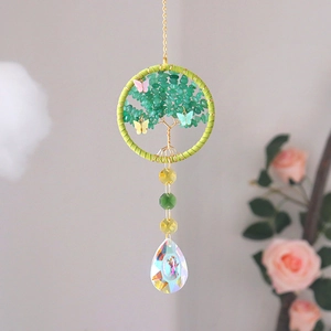 Detail of life tree crystal suncatcher with green stones and iridescent pear pendant