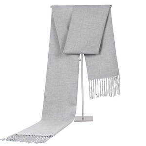 Classic men's minimalist grey winter scarf with tassel fringe on metal display stand