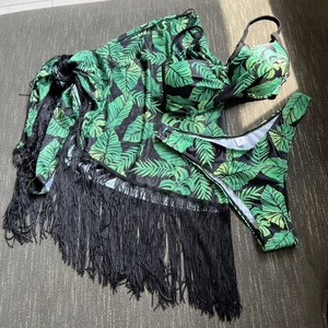 Detail of tropical palm leaf print bikini with fringed mesh cover-up three-piece set