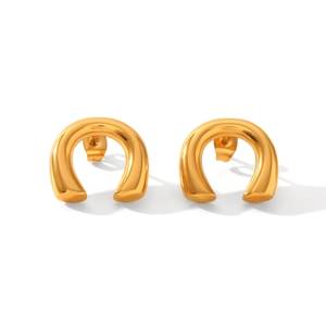 Detailed close-up of golden U-shaped stud earrings with smooth polished metallic finish