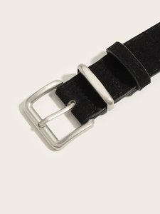 Detail of black suede belt with vintage silver pin buckle and matte leather texture