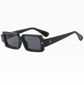 Close-up of black square sunglasses with classic silver triple rivet decorative details
