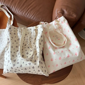Large cotton tote bags with vintage floral prints on a rustic wooden table