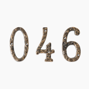 Vintage style bronze cast iron house numbers zero four and six with hammered texture