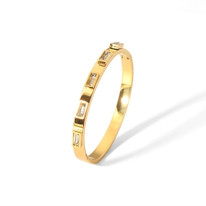 Detailed macro of 18K gold-plated stainless steel bangle with five rectangular zircons