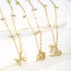 Gold plated zodiac necklace set featuring Pisces and Cancer pendants with zircon stones