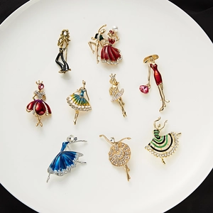 Set of stylish enamel ballet dancer brooches with rhinestones on white plate