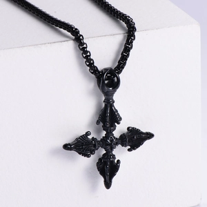 Gothic black cross pendant necklace with textured pillar detail on white background