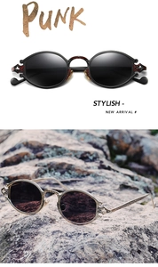 Detail of punk style oval sunglasses with intricate metal floral carvings on the frame