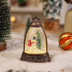 Detail of vintage bronze Christmas lantern with snowman and swirling glitter in snow scene
