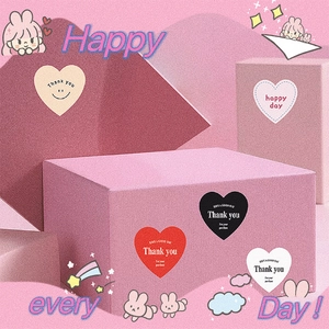 Colorful heart shaped thank you stickers on gift boxes for creative decoration