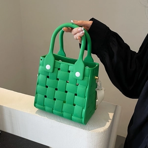 Green EVA woven tote bag with white buckle accents and hollow mesh design for beach travel