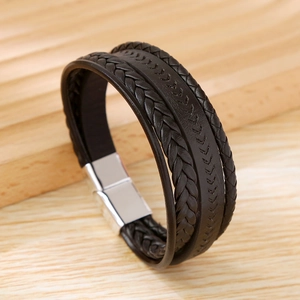 Close-up of dark brown braided leather men's bracelet with silver magnetic clasp