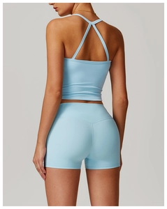 Close-up of cross back straps and texture on a light blue sports yoga vest set
