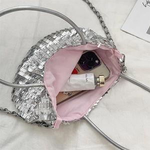 Macro shot of silver sequin bag with pink fabric lining showing daily storage capacity