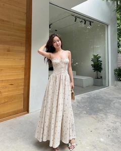 Floral midi dress with lace stitching and smocked waist design shown in a street view