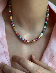 Detail of 18k gold plated beaded necklace with colorful natural stones on model