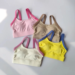 Flat lay detail of four seamless high-support sports bras in pastel colors for women