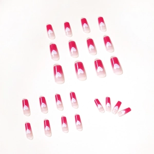 Raspberry red ombre press-on nails with white heart patterns in a square-oval shape