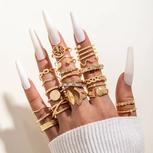 Detailed view of a gold boho ring set featuring crystal accents and hollow tree design