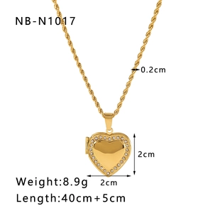 Detailed view of a gold heart locket necklace with sparkling white rhinestones and twist chain
