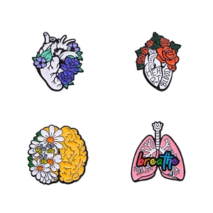 Set of 4 anatomical organ enamel pins featuring floral brain, heart, and lung designs