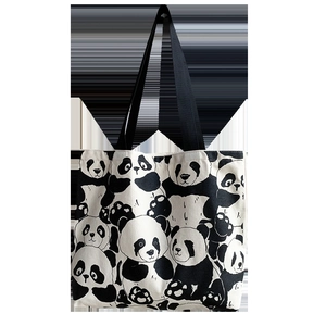 Detailed pattern of a white canvas tote bag with cute cartoon panda prints and black handles