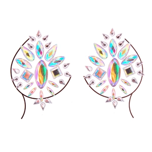 Close-up of iridescent acrylic face jewels with symmetrical floral patterns and sparkles