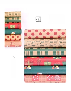 Detail of Christmas wrapping paper rolls with festive Santa and snowflake patterns