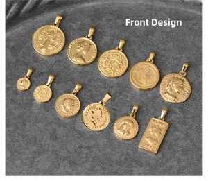 Detail of assorted vintage 18K gold plated titanium steel coin and shield pendants