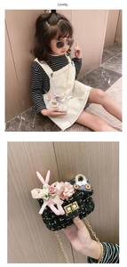 Detail of tweed girl's purse with 3D floral accents, ribbon bow and bunny charm