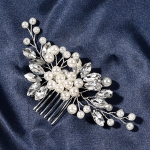 Macro shot of silver bridal hair comb with pearls and marquise rhinestones detail