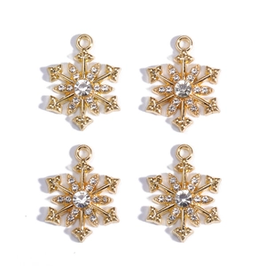 Detailed view of four gold snowflake pendants with sparkling zircon crystal accents