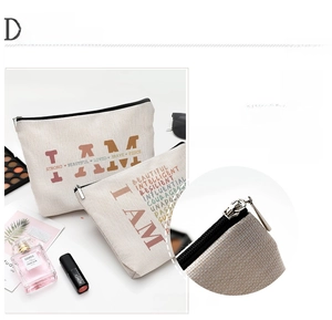 Detailed view of canvas makeup bags featuring inspirational text and zipper closure