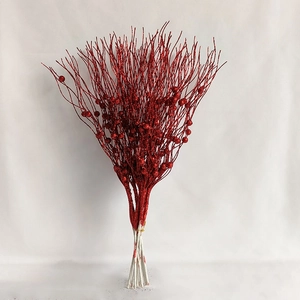 Close-up of red glitter Christmas berry stem and sparkle decorative branch for holiday decor