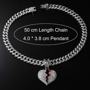 Close-up of hip hop silver broken heart pendant with red details and 50cm cuban chain
