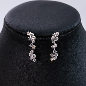 Detailed view of silver zircon flower earrings with sparkling crystals for bridal wear