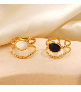Detail of double-layered 18K gold-plated adjustable rings with oval marble and black inlay