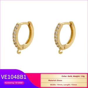 Close-up of gold-plated brass hoop earrings with white zircon and small hanging loop