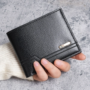 Men's bifold wallet in black lychee leather with a gold metal bar and blue gemstone detail