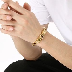Detailed close-up of gold double wolf head bracelets for men in punk style