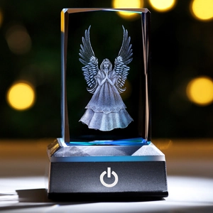 3D laser engraved crystal angel figurine with glowing LED base and warm bokeh background