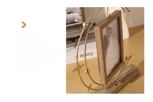 Detailed view of rotating golden metal frame with star accent and wooden texture