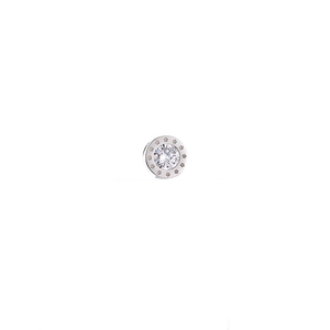 Macro shot of silver titanium steel earring with star pattern and clear zircon stone