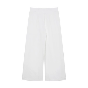 Detail of high-waist white wide-leg linen trousers with elegant pleated waist design
