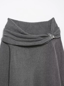 Detail of grey off-shoulder knit sweater featuring stylish silver triple ring metal accents