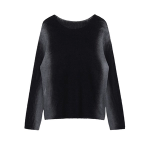 Detailed view of black crewneck knit top showing the silky texture and fine stitching