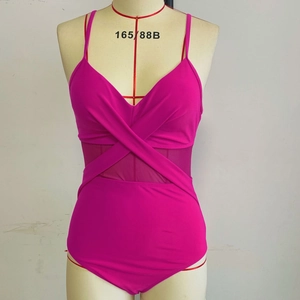 Detail of rose red one-piece swimsuit with cross V-neck and mesh patchwork on the waist
