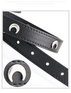 Close-up of black leather belt with silver crescent moon studs and metal rivets detail